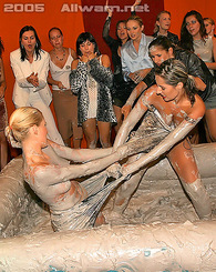 Erotic chicks wrestling each other and covered in thick mud